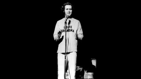 Andy Kaufman onstage in 1977, wearing a "I love grandma" sweater after doing one of his trademark Elvis impersonations.