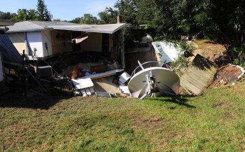 The rear portion of a residential home is consumed by a sinkhole November 14 in Dunedin, Florida.