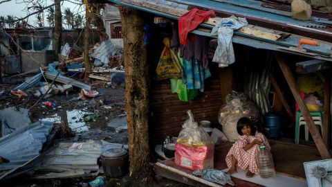 A girl plays inside her house amid the devastation in Tacloban on November 14.