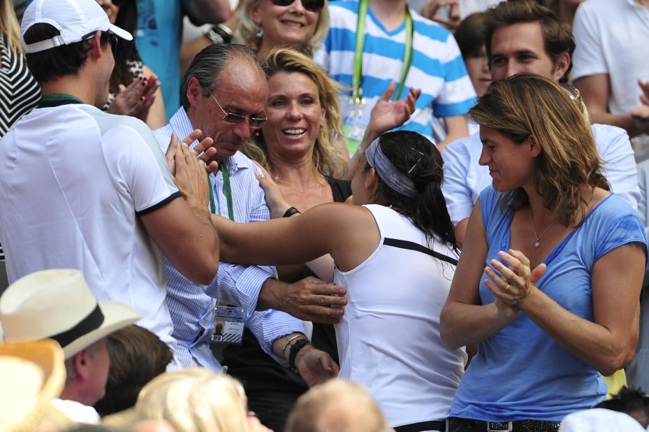 Bartoli made her way to her player box after the final and exchanged hugs with her team, which included dad Walter (middle) and former Wimbledon champion Amelie Mauresmo (right) who now coaches Andy Murray.