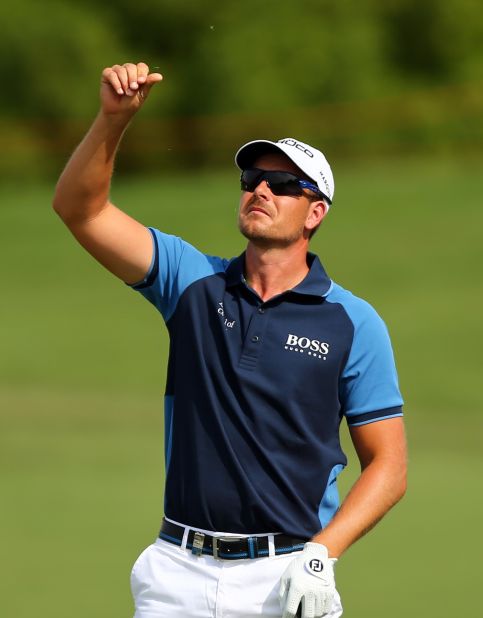 Henrik Stenson checks the wind during his opening round of four-under. He is the favorite to claim the Race to Dubai crown after a stellar season, which also saw him take the PGA Tour's FedEx Cup. If he were to win the European Tour's season finale he'd be the first golfer ever to do the double.