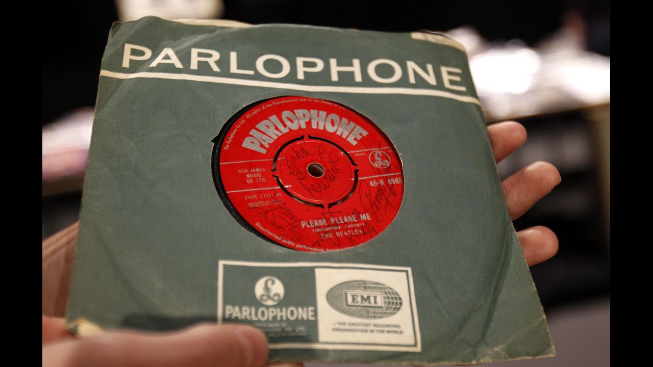 The Beatles released their first album, "Please Please Me," in the United Kingdom on March 22, 1963. A 7-inch copy of the single, seen here, was signed on both sides by the Fab Four and sold in 2011 for more than £9,000.