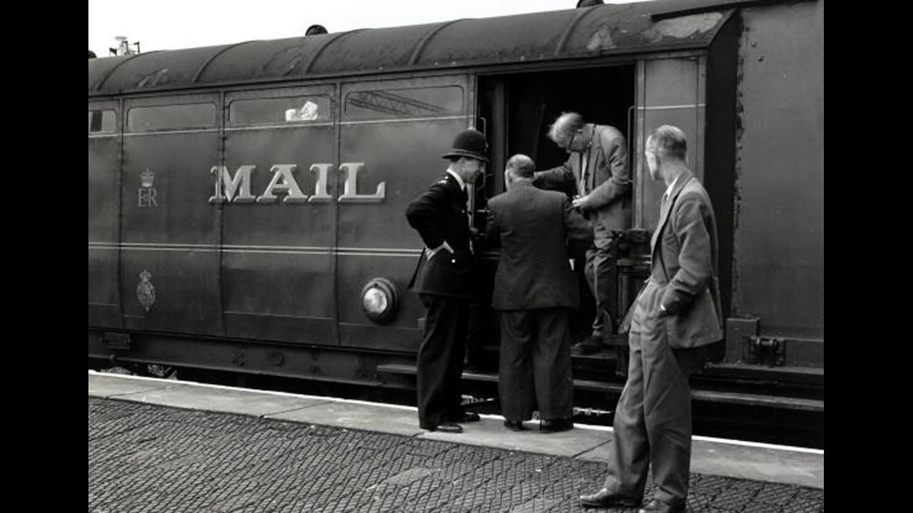 Detectives inspecting the Royal Mail train from which more than £2.5 million was stolen. The Great Train Robbery took place in Buckinghamshire on August 8,1963, when the train from Glasgow to London was halted by a gang.