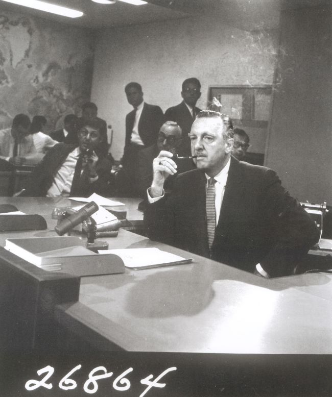 Walter Cronkite sits behind the news desk on the set of the "CBS Evening News with Walter Cronkite" in August 1963. One month later, it became network television's first nightly half-hour news program.