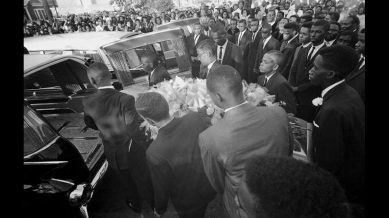 A coffin is loaded into a hearse at a funeral in Birmingham, Alabama, for victims of <a href="index.php?page=&url=http%3A%2F%2Fwww.cnn.com%2F2013%2F09%2F14%2Fus%2Fbirmingham-church-bombing-anniversary-victims-siblings%2F">the 16th Street Baptist Church bombing</a>. Four African-American girls were killed and at least 14 others were wounded when a bomb blast tore through church services on September 15, 1963. Three former Ku Klux Klan members were later convicted of murder for the bombing.