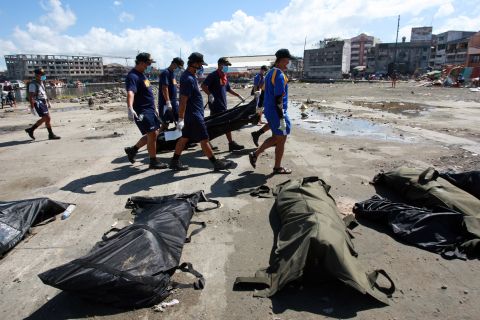 Search and retrieval teams carry a body bag in Tacloban on November 15.