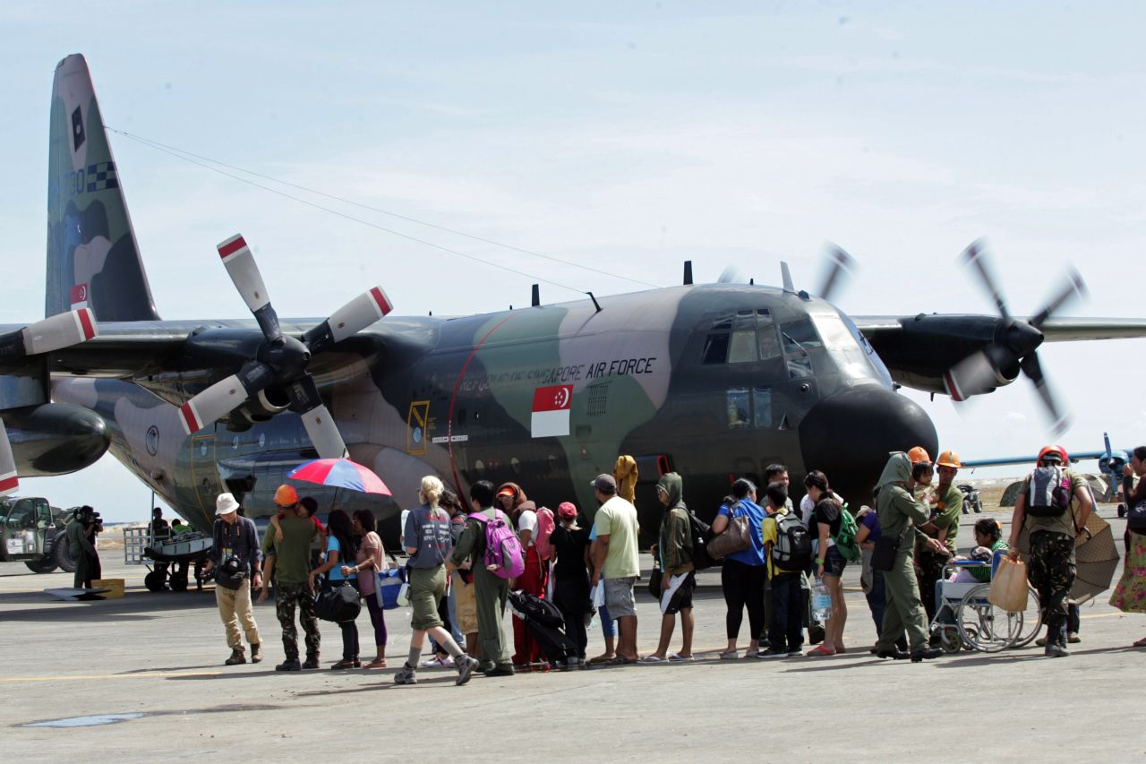 Residents wait to board a Singaporean cargo plane at the Tacloban airport on November 15. Many survivors have converged on the city's airport to wait for flights.