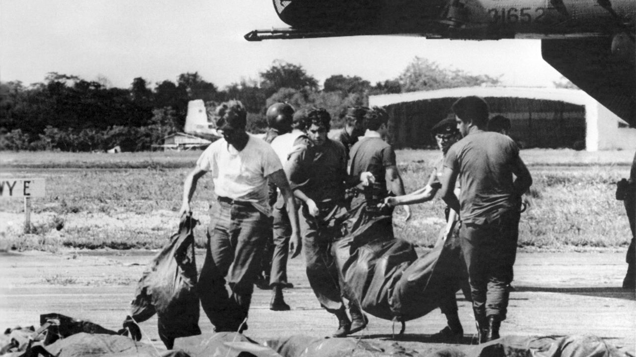 U.S. military personnel remove bags containing bodies of members of the cult on November 23, 1978.