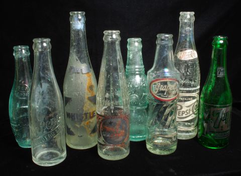 1885-1966: A sample of the recovered soft-drink bottles. The bottling industry first used applied color labels in 1934.