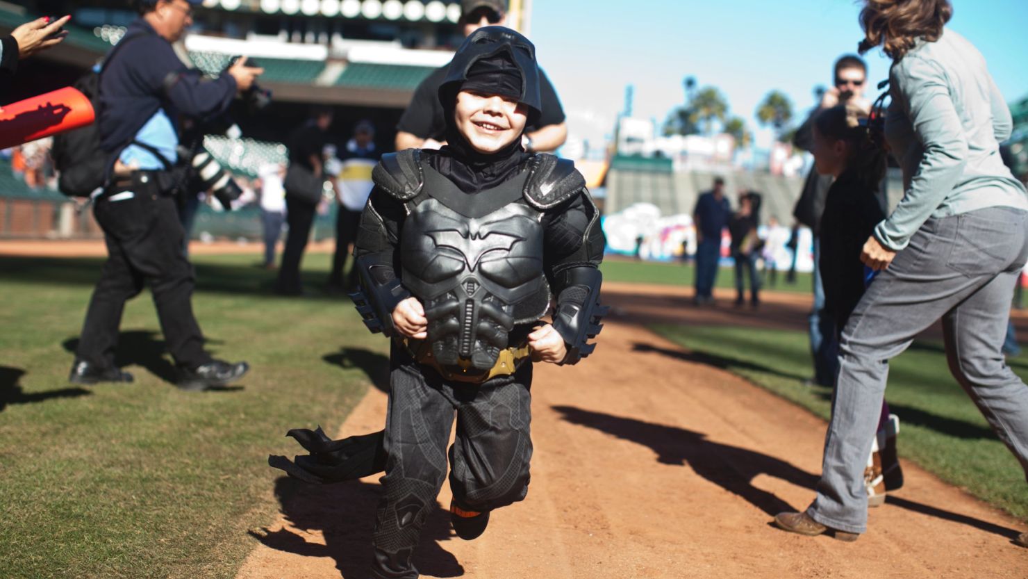 Leukemia survivor Miles Scott dressed as BatKid, runs the bases at AT&T Park in San Francisco on November 15, 2013.