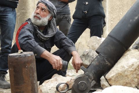 A rebel fighter prepares an improvised mortar shell in Aleppo, Syria, on Saturday, November 9.