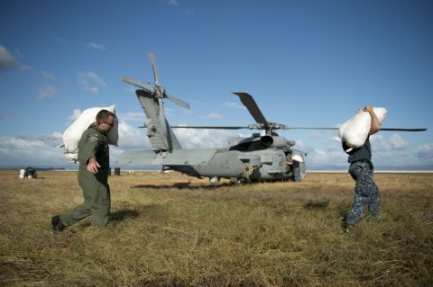 U.S. servicemen load emergency supplies onto a helicopter November 16 at the airport in Tacloban.