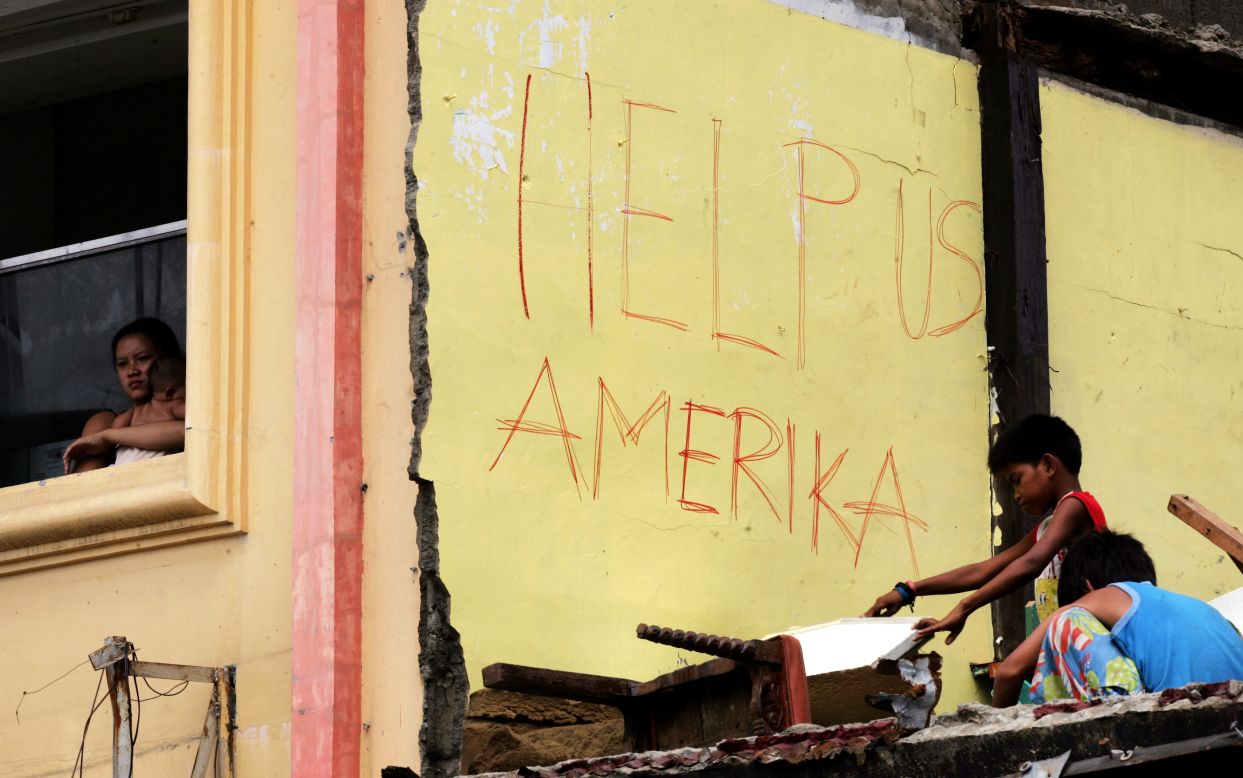 Survivors appeal for U.S. help November 16 in Tacloban.