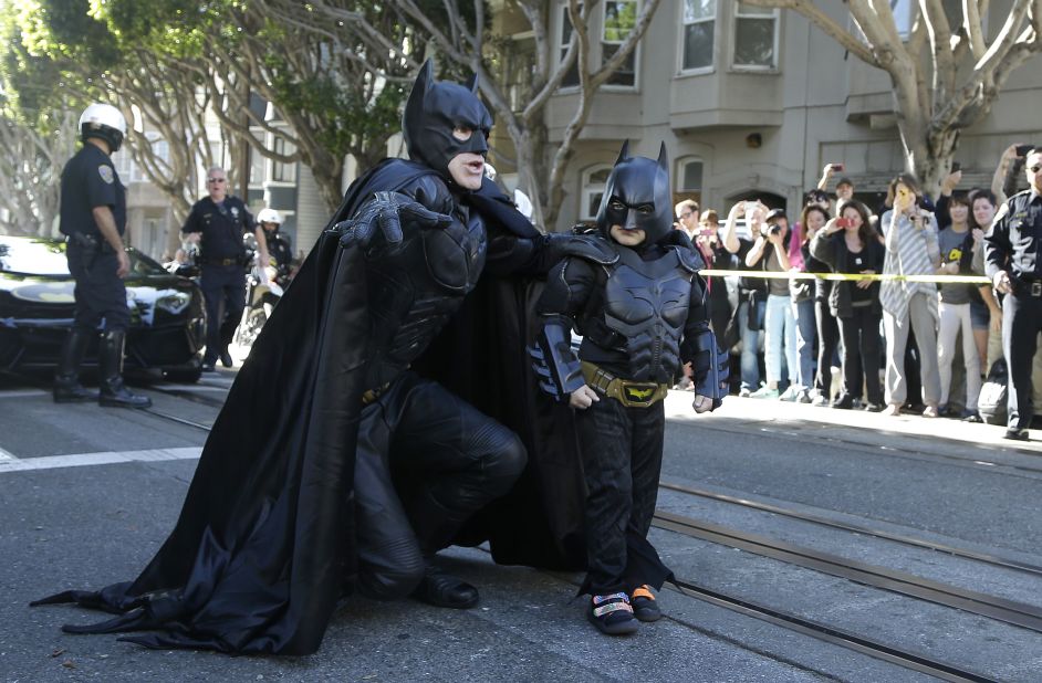Miles Scott, dressed as "Batkid," right, walks with Batman before saving a damsel in distress in San Francisco, in November 2013. The City by the Bay turned into Gotham City on Friday, as city officials helped fulfill Scott's wish to be Batkid. Scott, a leukemia patient from Tulelake, California, was called into service by San Francisco Police Chief Greg Suhr to help fight crime. The event was part of The Greater Bay Area Make-A-Wish Foundation.