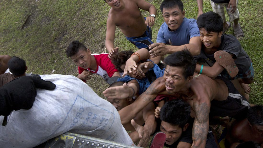 Stranded villagers scramble for aid supplies in Tanauan on November 17.