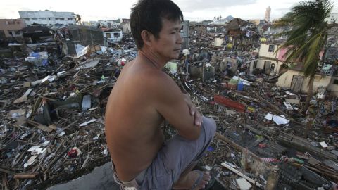 A man looks over the devastation from his damaged home in Tacloban on November 17.