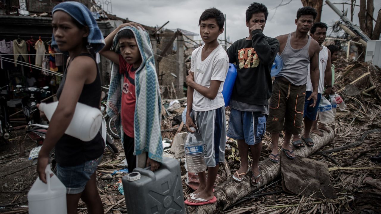 People wait in line for drinking water November 17 in Palo, Philippines.
