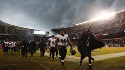 Baltimore Ravens players leave the field as play was suspended for a severe thunderstorm blowing through Soldier Field during the first half of an NFL football game against the Chicago Bears, Sunday, Nov. 17, 2013, in Chicago. (AP Photo/Charles Rex Arbogast)
