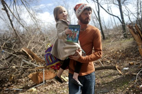 Billy Vestal evacuates his home in East Peoria, Illinois, with his 3-year-old daughter, Lillian Vestal, after a tornado damaged the area on November 17.