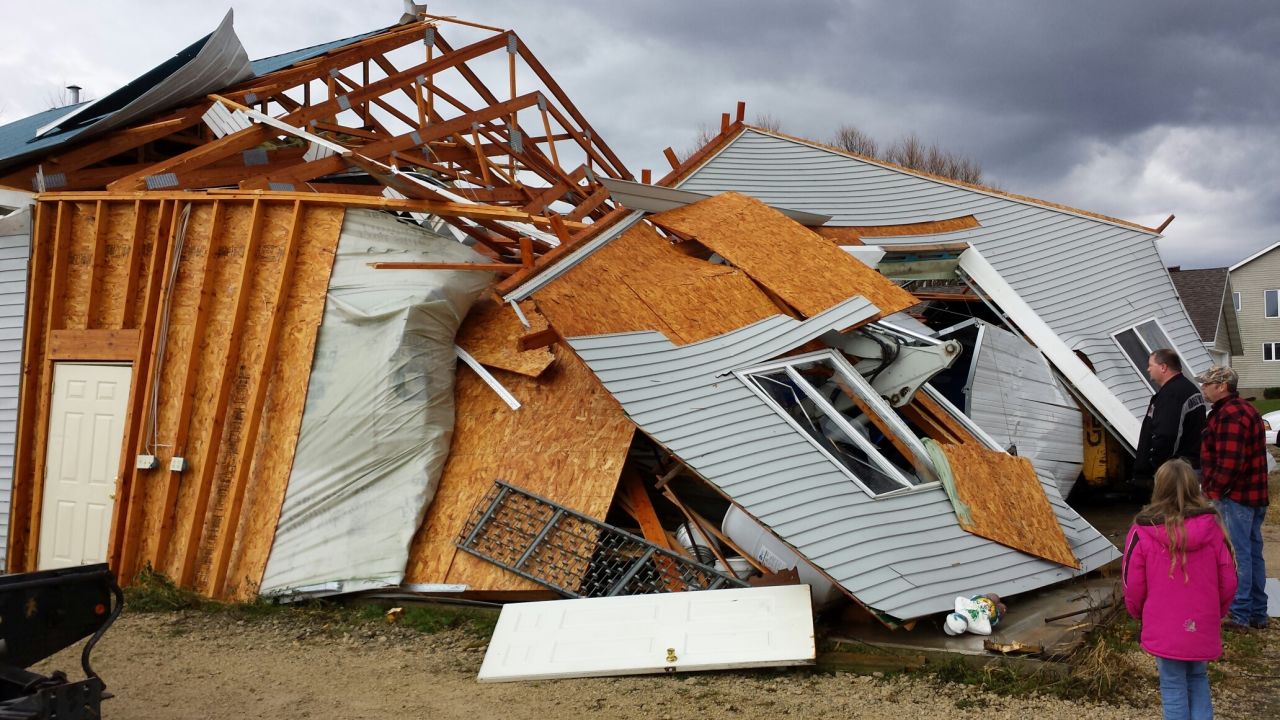 People survey storm damage on November 17 in Hustisford, Wisconsin, which is northwest of Milwaukee.