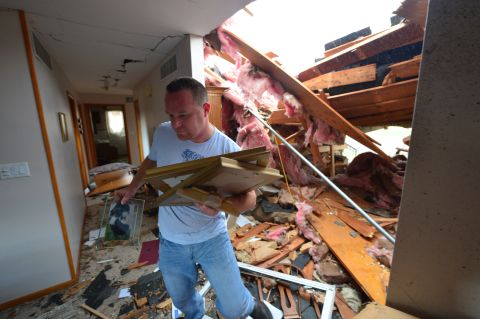 Josh Ramsey recovers items from the house of a family friend after a tornado tore through the north end of Pekin, Illinois, on November 17.