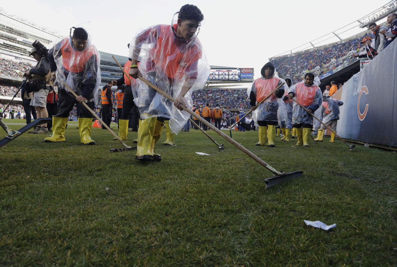 Members of Soldier Field's ground crew prepare the field to resume play after a severe storm blew through the area on November 17 and suspended play during the first half of the game between the Chicago Bears and Baltimore Ravens.