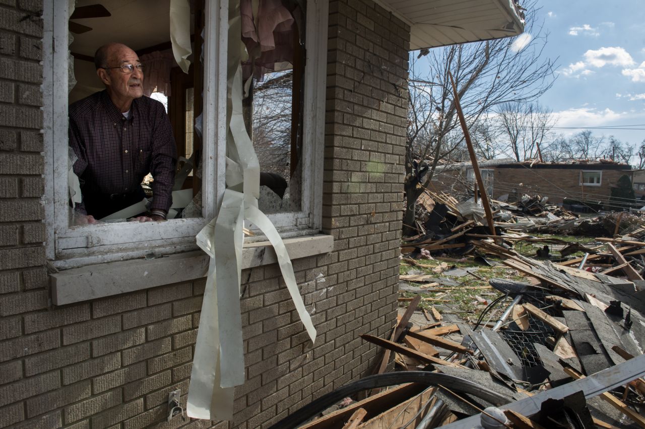 Chuck Phillips looks out at the destruction that tore off part of his roof and destroyed homes in his neighborhood on November 17 in Pekin.