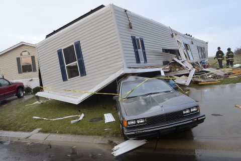 Firefighters look over damage to trailers at Summit Village, east of Marion, Indiana, after storms blew through Marion and Grant County, northeast of Indianapolis, on November 17.