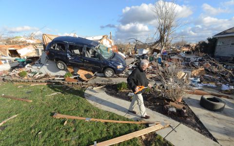 Richard Miller salvages items from his brother's home in Washington, Illinois, on November 17.