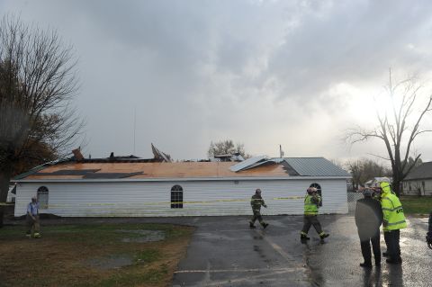 Firefighters stretch caution tape around the New Life Tabernacle Church in Paducah, Kentucky, on November 17.