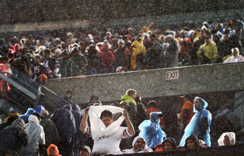 Fans begin to clear the stands during the rain and high winds at Soldier Field in Chicago on November 17.