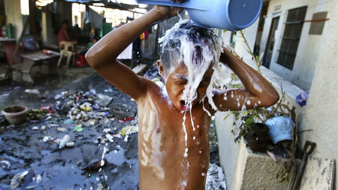 A boy bathes November 18 at a Tacloban school turned into a temporary shelter.