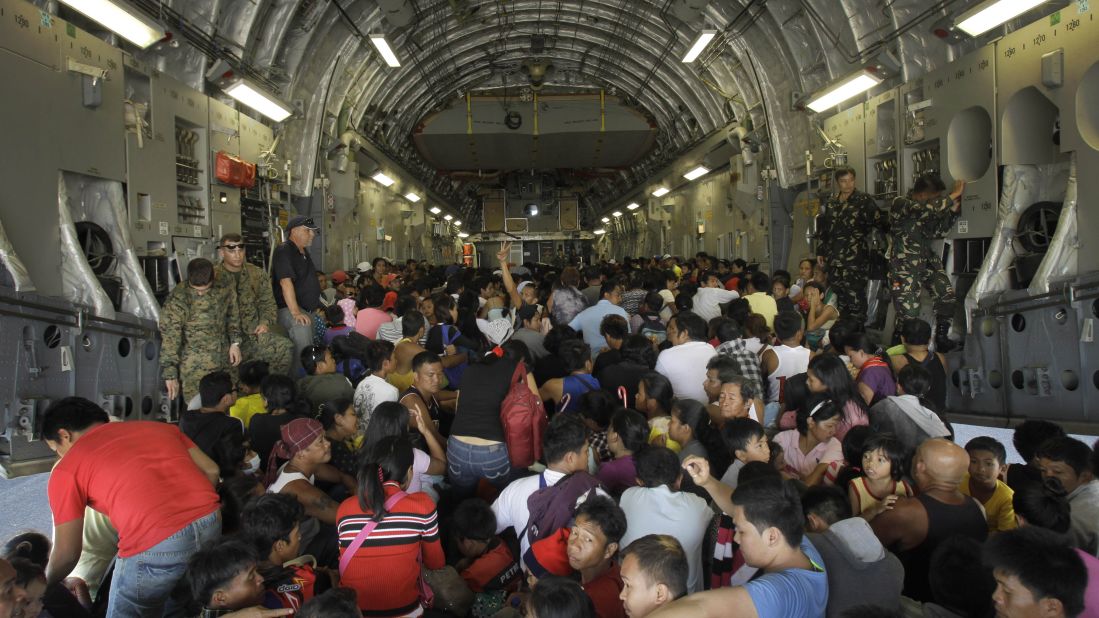 Hundreds of typhoon survivors are packed into a U.S. military airplane November 18 for evacuation from Tacloban's airport.