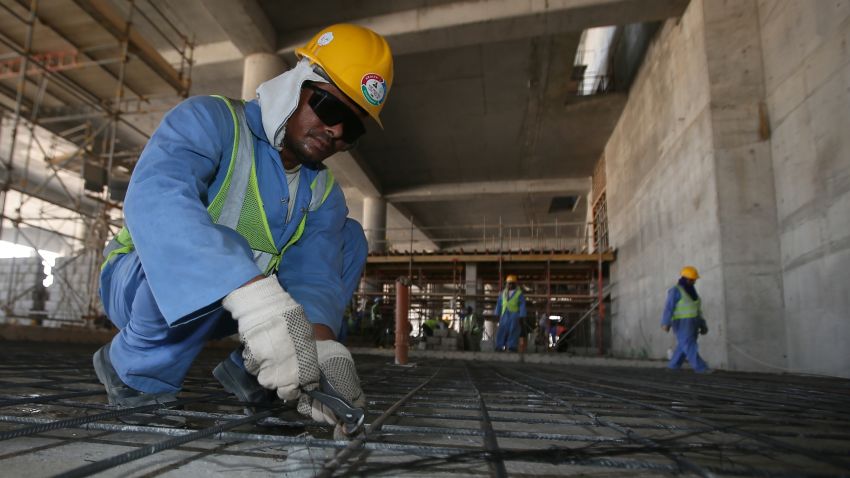 Migrant labourers work on a construction site on October 3, 2013 in Doha in Qatar. Qatar, the 2022 World Cup host is under fire over claims of using forced labour.
