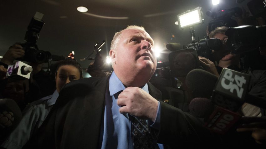 Toronto Mayor Rob Ford makes his way to the council chamber in Toronto on Friday, Nov. 15, 2013. Toronto's City Council voted overwhelming to strip Mayor Rob Ford of some of his powers in the latest attempt to box in the brash leader who has rebuffed huge pressure to resign over his drinking and drug habits and erratic behavior. Ford vowed to fight it in court. Council passed the motion 39-3. (AP Photo/The Canadian Press, Chris Young)