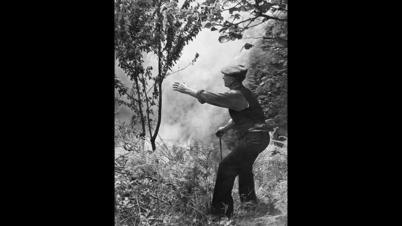 A man near the village of Sant'Alfio watches lava flow from Etna in 1971.