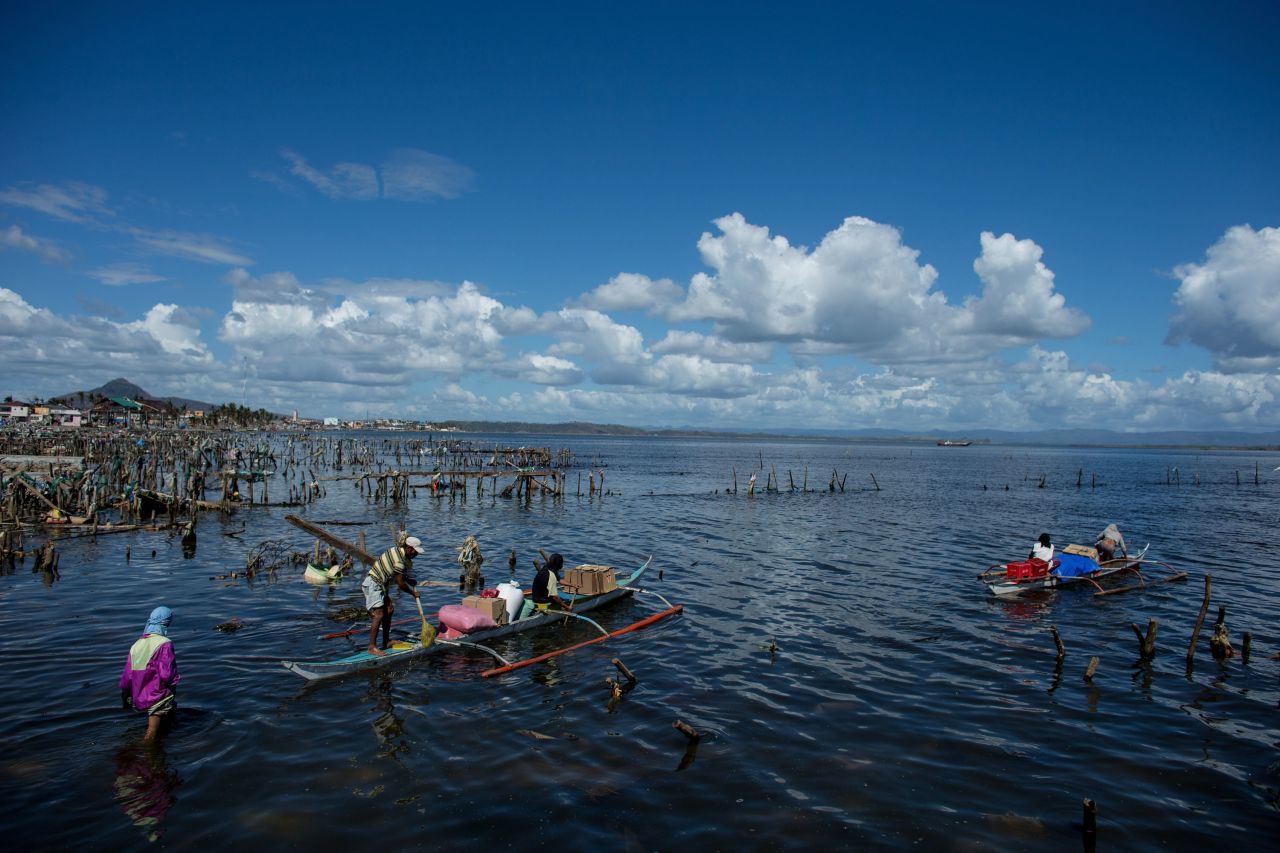 Men take food back to their families in Leyte on November 18. Countries all over the world have pledged relief aid to those affected by the typhoon, but damage to airports and roads have made moving the aid very difficult.