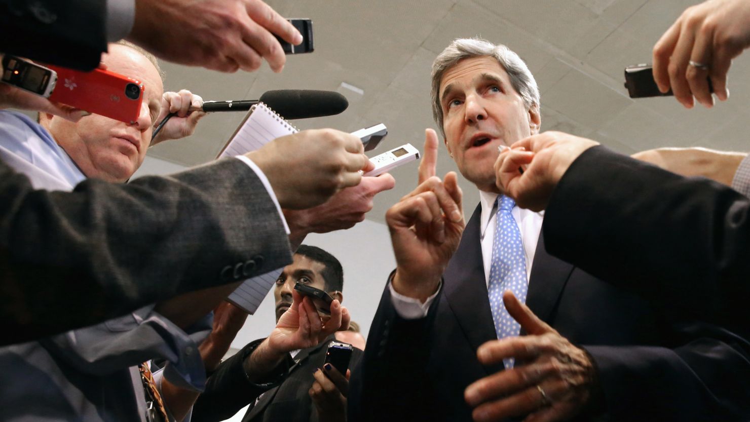 U.S. Secretary of State John Kerry speaks with reporters before briefing a Senate committee on  negotiations with Iran.
