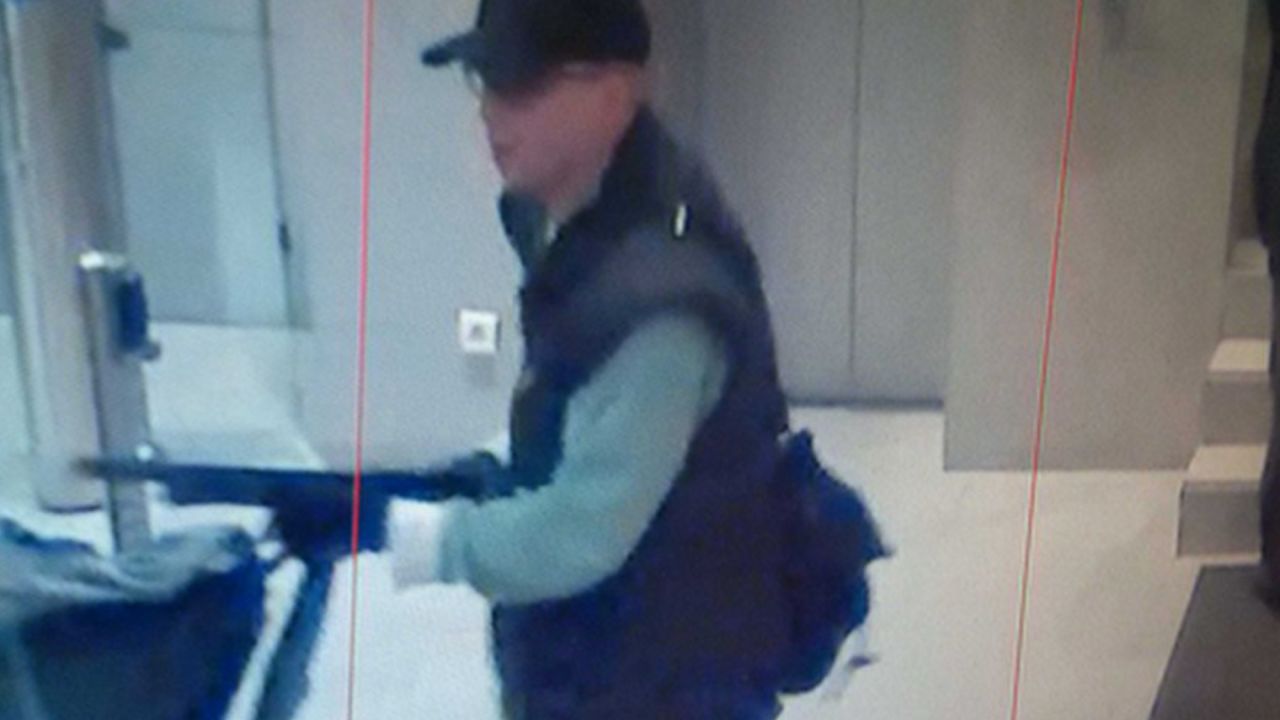 This photo taken from a footage of a security camera on Friday, Nov. 15, 2013, and released by the Paris Prefecture de Police, Monday, Nov. 18, 2013, shows a man pointing a shotgun at employees of the BFM TV station in Paris, France.The Paris prosecutor, Francis Molins, says a lone gunman appears to be behind a shooting at a Paris newspaper office that gravely wounded a photographer, and three other attacks. Monday's events happened three days after a gunman threatened journalists at the BFM-TV news network. (AP Photo/Prefecture de Police)
