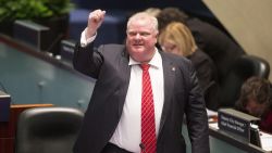 Toronto Mayor Rob Ford raises his fist in a mock salute in the council chamber as Councillors look to pass motions to limit his powers in Toronto on Monday, Nov. 18, 2013. Rob Ford faced another likely setback Monday as the City Council took up a motion to snatch away many of his remaining powers in a heated council meeting where he knocked over a woman councilor. Ford called the effort a "coup d'etat" and challenged the council to call snap elections. (AP Photo/The Canadian Press, Chris Young)