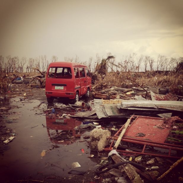 An abandoned van lies amid the vast sea of debris around a village close to Tacloban's airport on November 14.