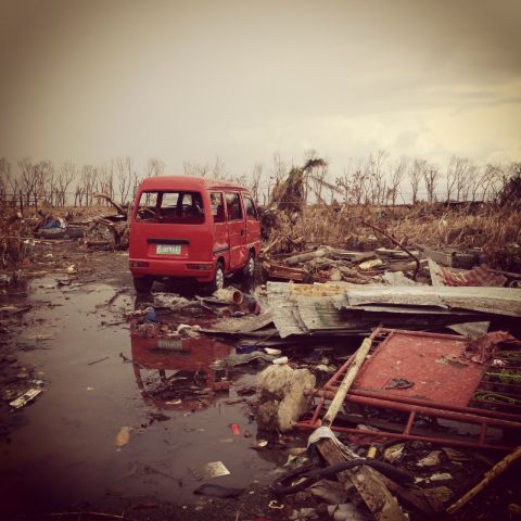 An abandoned van lies amid the vast sea of debris around a village close to Tacloban's airport on November 14.