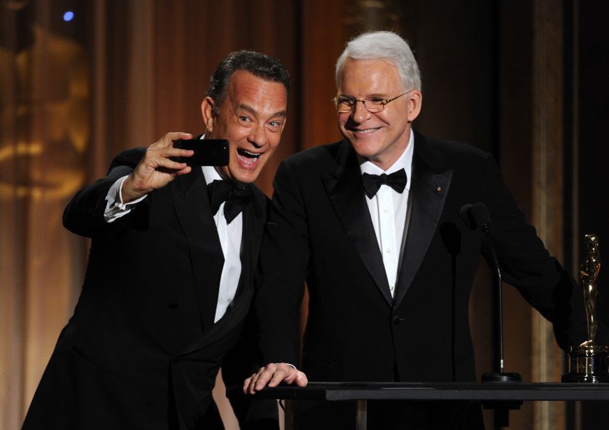 Tom Hanks takes a selfie with fellow actor Steve Martin at the 2013 Governors Awards.