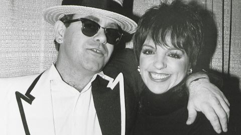 John with actress and singer Liza Minnelli in 1990.