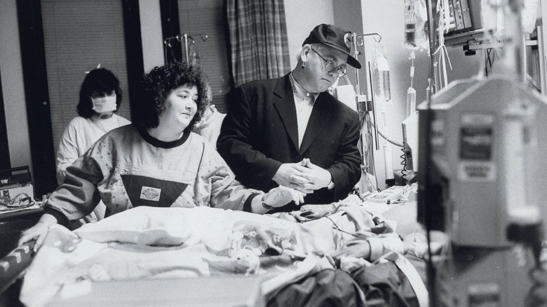 John stands by the bed of AIDS patient Ryan White at a Florida hospital in 1990. Two years later, the singer established the Elton John AIDS Foundation.