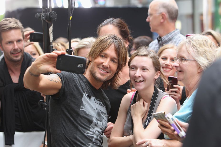 Musician Keith Urban takes a selfie with a fan before performing at NBC's "Today" show. 