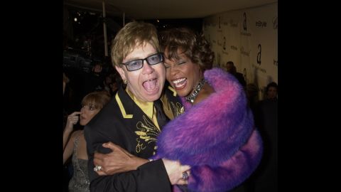 Whitney Houston hugs John at the Academy Awards in 2001. A few years earlier, John had won an Oscar for "Can You Feel The Love Tonight," his song in Disney's "The Lion King."
