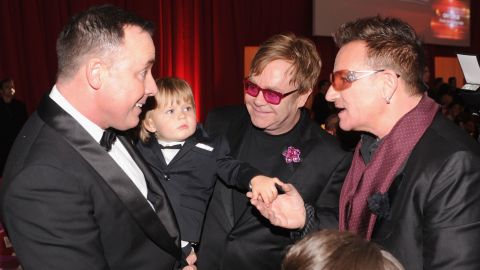 U2 singer Bono, right, talks with John, Furnish and their son Zachary at an Academy Awards viewing party in 2013.