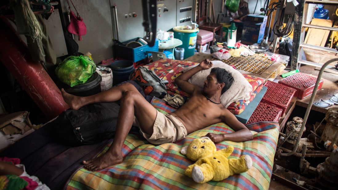 A man sleeps on Tuesday, November 19, on a tanker that ran aground during Typhoon Haiyan in Tacloban.