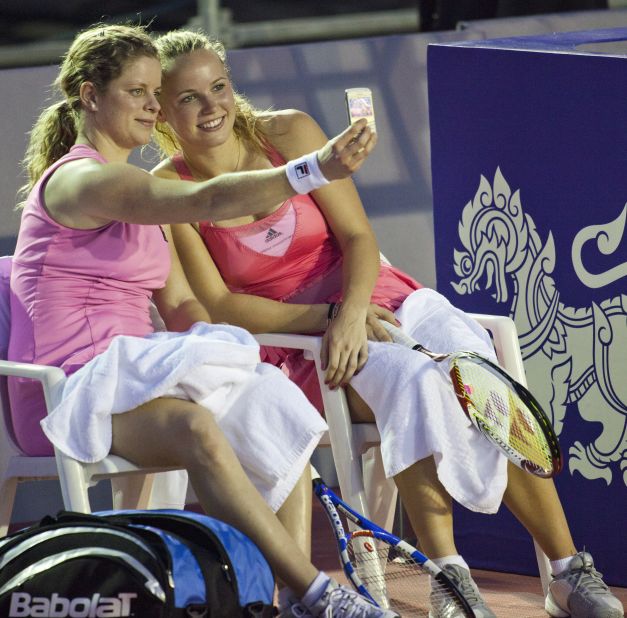 Now-retired tennis player Kim Clijsters takes a selfie with Caroline Wozniacki during an exhibition match in Hua Hin, Thailand.